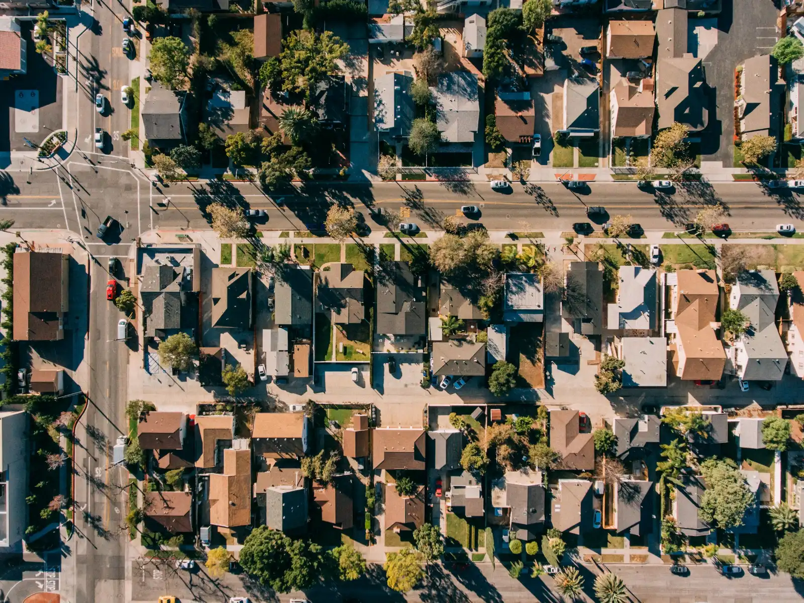 Aerial view of a residential neighborhood of single-family homes and tree-lined streets in Orange, California